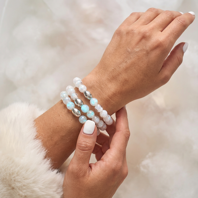 NOGU Cloud Dance stackable bracelets with luminous white and iridescent beads, accented by polished silver-toned links.
