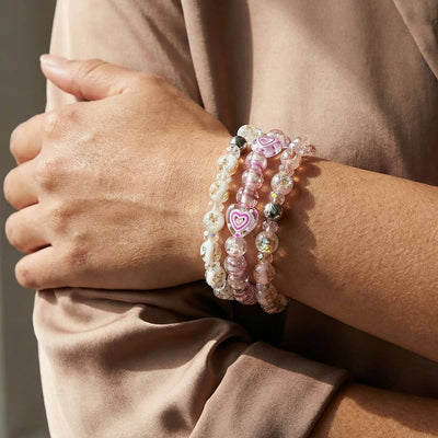 NOGU 2026 Valentine Stacks of pink, white and clear glass bead bracelets with heart charms and sparkling accents.
