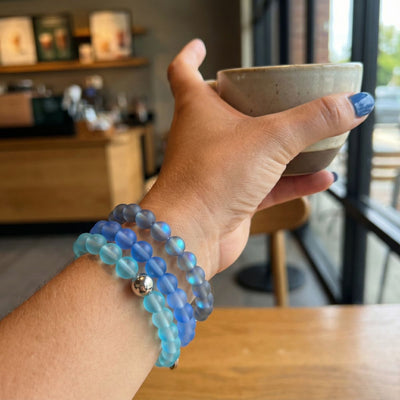 NOGU Made to Pair Grey Mermaid Glass™ bracelet stack with luminous grey, blue, pink and white glass beads.
