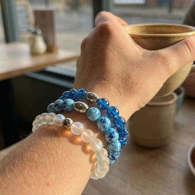 NOGU Made to Pair Topaz Flame stack with blue marbled, deep blue and milky white beaded bracelets with silver accents.