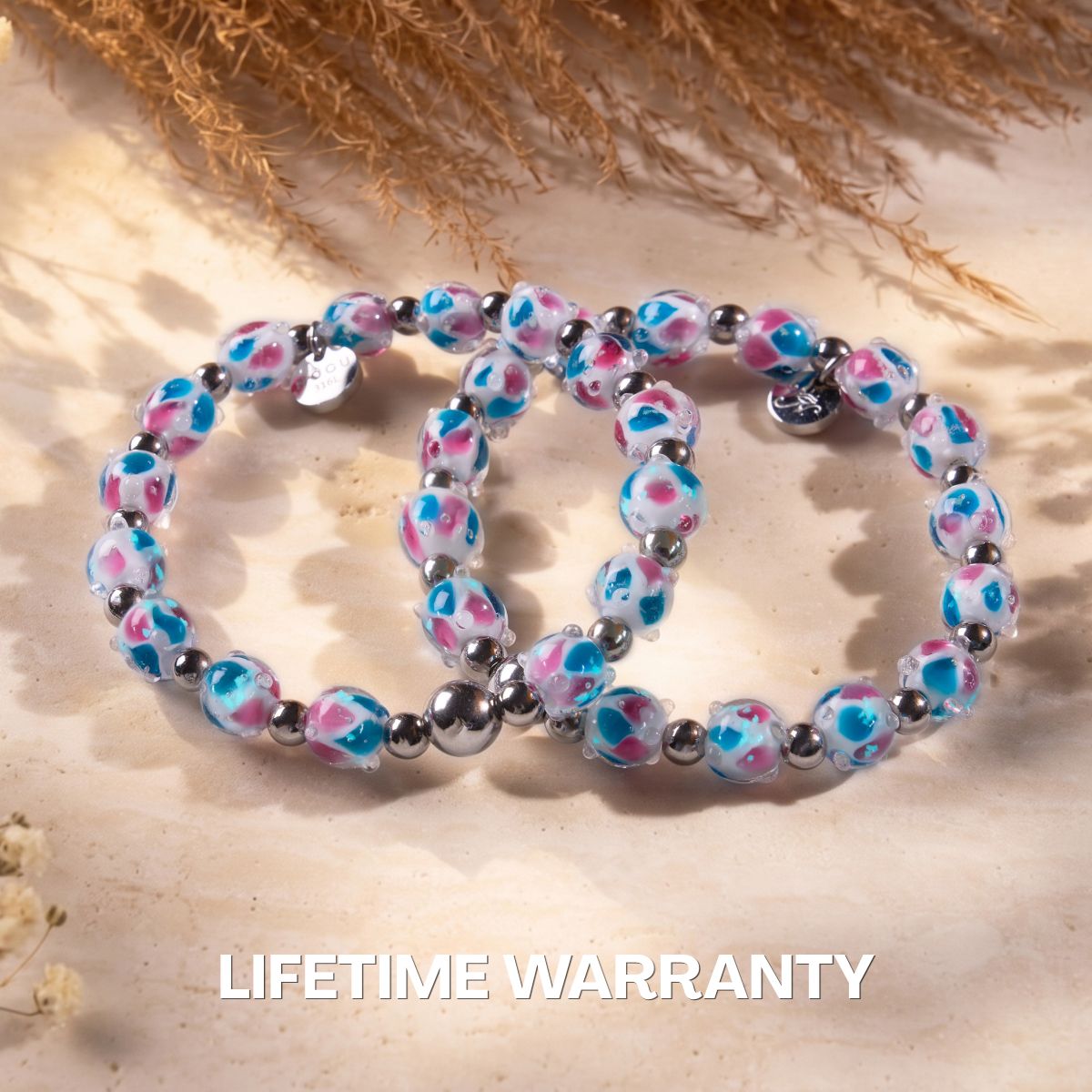 NOGU beaded bracelet set with pink and turquoise floral glass beads and polished silver-tone spacer beads.