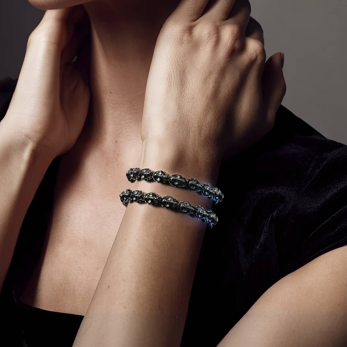 Hades bracelet glowing with adjustable Black GlowWeave cord and Hematite skull beads on stainless steel base by NOGU