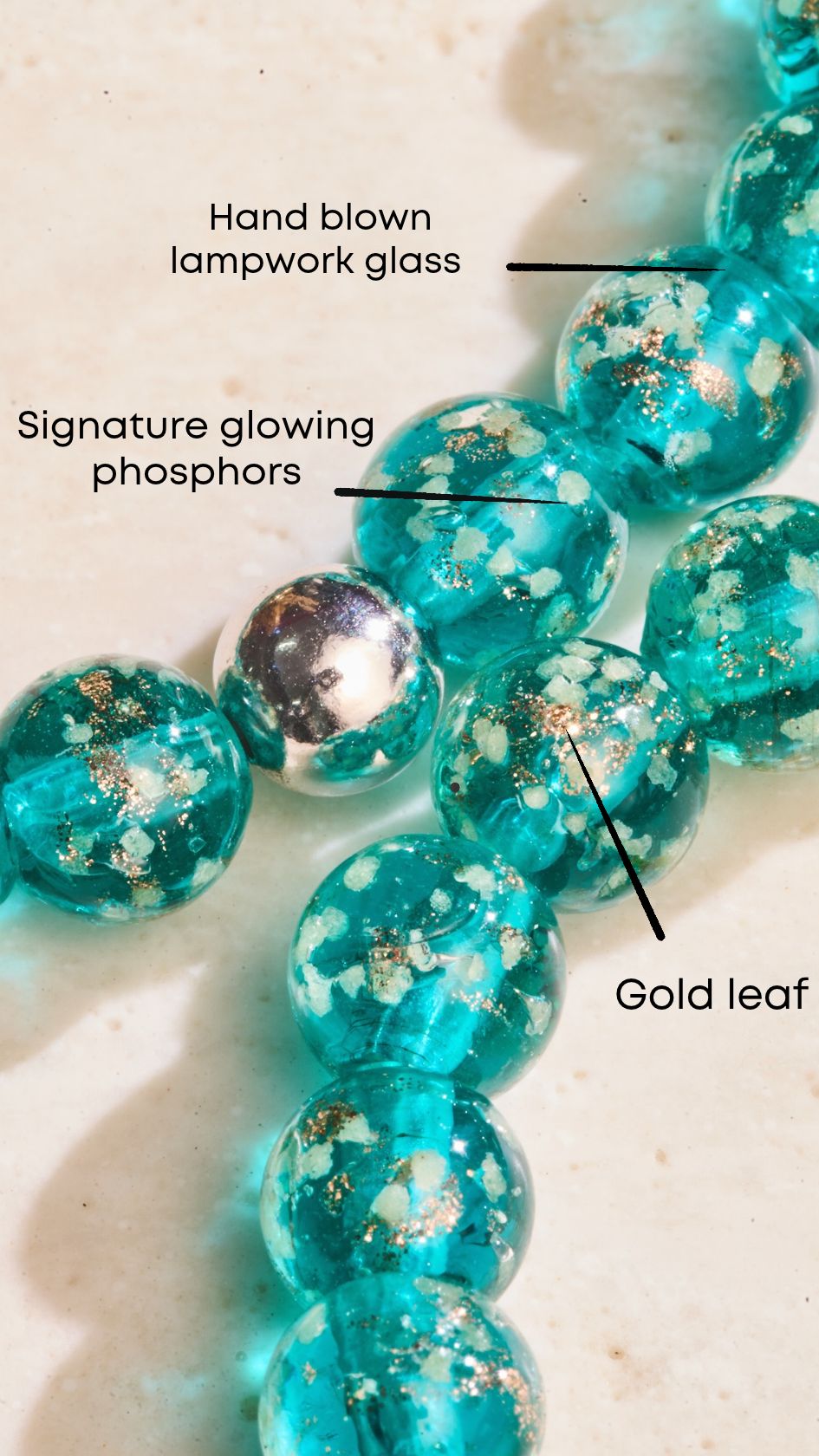 Turquoise hand-blown lampwork glass bead bracelet with glowing phosphors, gold leaf flecks, and a silver-tone bead.