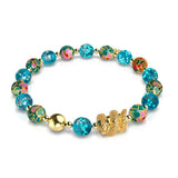 Bracelet serpent en verre bleu sarcelle et motif luciole, dragon de mer, lotus en émail