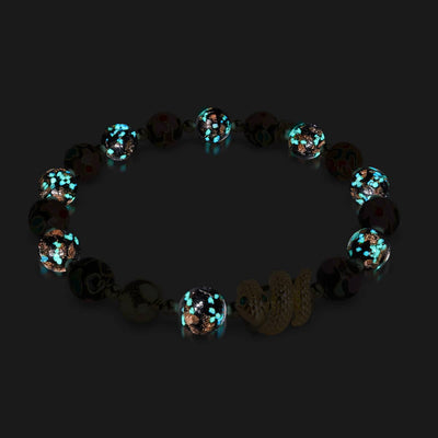 Shadow Dragon bracelet with glowing onyx Firefly glass beads and 18k gold plated serpent charm by NOGU