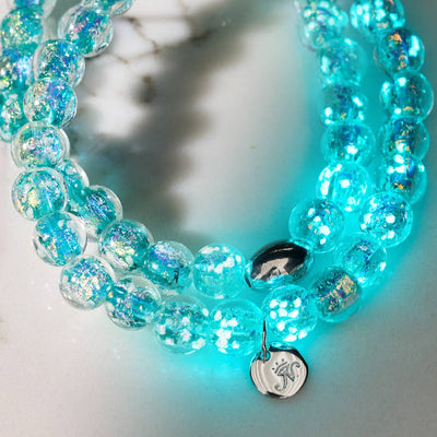 Aurora Spark double wrap bracelet with glowing turquoise Firework Glass beads and .925 sterling silver charm by NOGU
