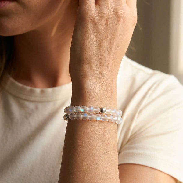 White iridescent Mermaid Glass bead bracelet with silver stainless steel accents, worn doubled on the wrist.