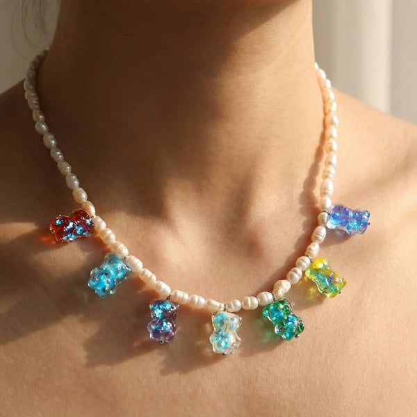 Freshwater pearl necklace with colorful glowing Firefly Glass gummy bear charms on a silver stainless steel chain.