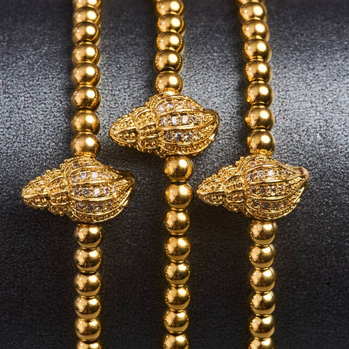île | Or 18 carats | Bracelet Charmballa en macramé avec coquille de conque en cristal
