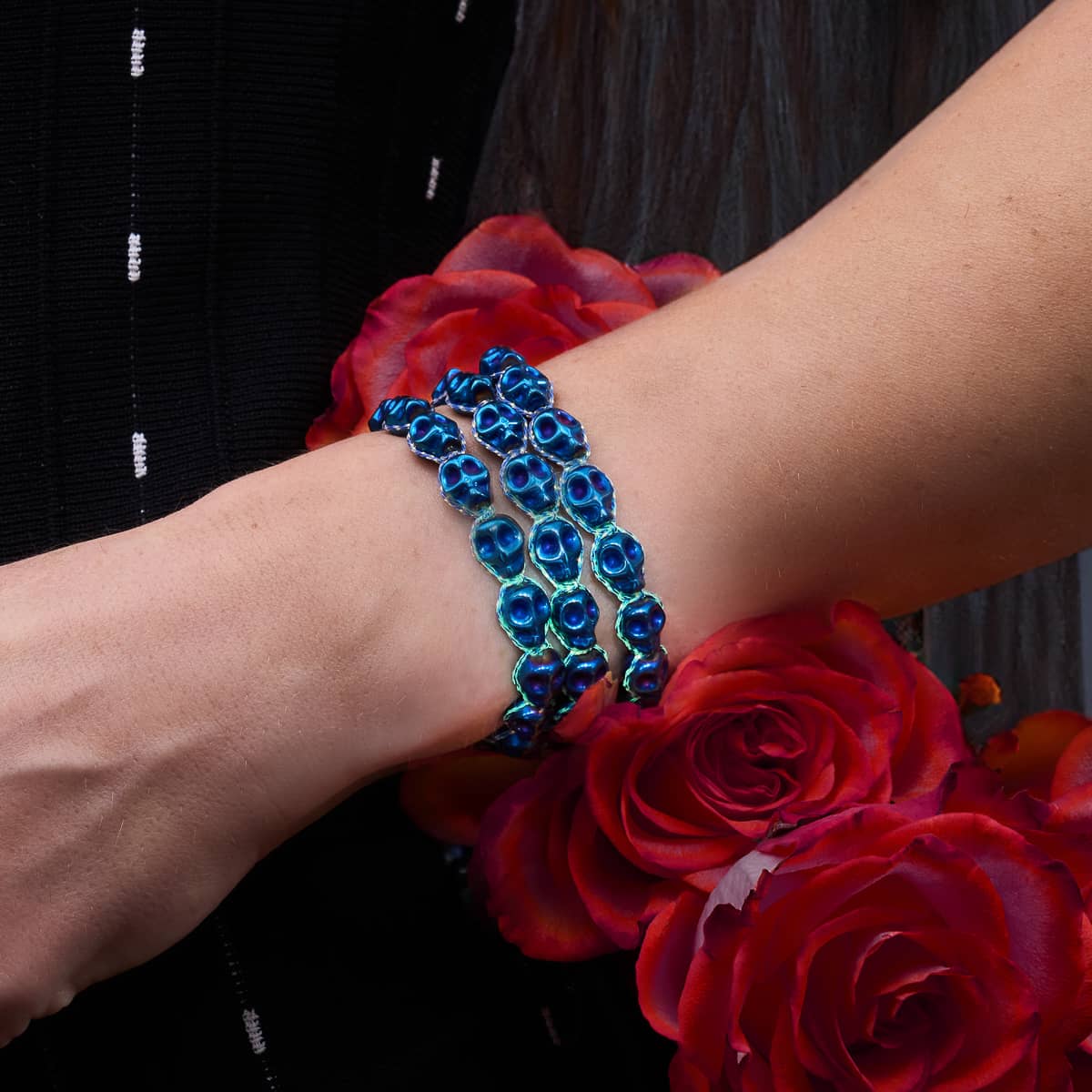 A close-up of a skull bracelet that glows in the dark, adding a spooky touch to any Halloween costume.