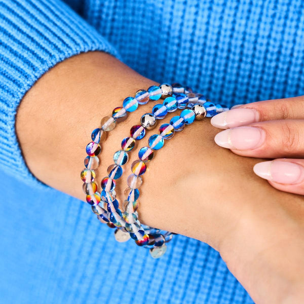 Indigo Borealis Galaxy Glass bead bracelet with iridescent 6mm beads and silver-plated stainless steel on wrist by NOGU