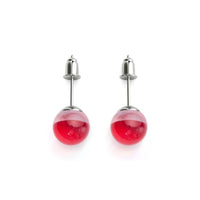 A close-up of the Blood Moon Galaxy Glass Stud Earrings, perfect for a celestial Halloween look.