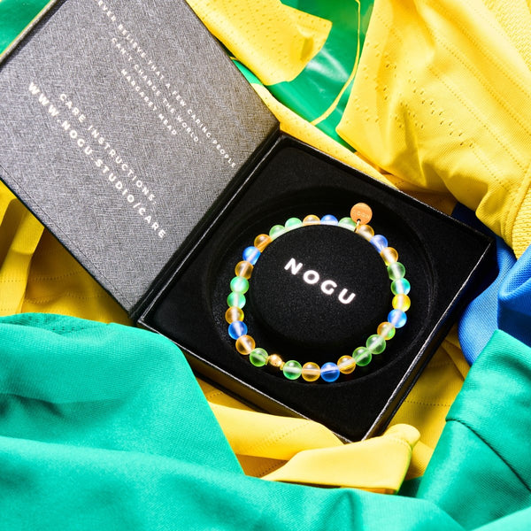 BRAZIL Mermaid Glass Nations Bracelet with 6mm iridescent beads and gold stainless steel charm in black box on colorful fabric by NOGU
